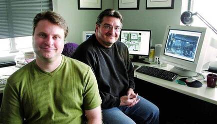Chris Reese y John Garvin en 2006. En el monitor, Syphon Filter: Dark Mirror.